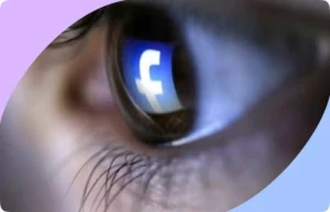 A close-up of a person's eye reflecting the Facebook logo, symbolizing the pervasive nature of social media and the importance of parental control in protecting children online, as endorsed by 10 million US parents through Safe Lagoon.